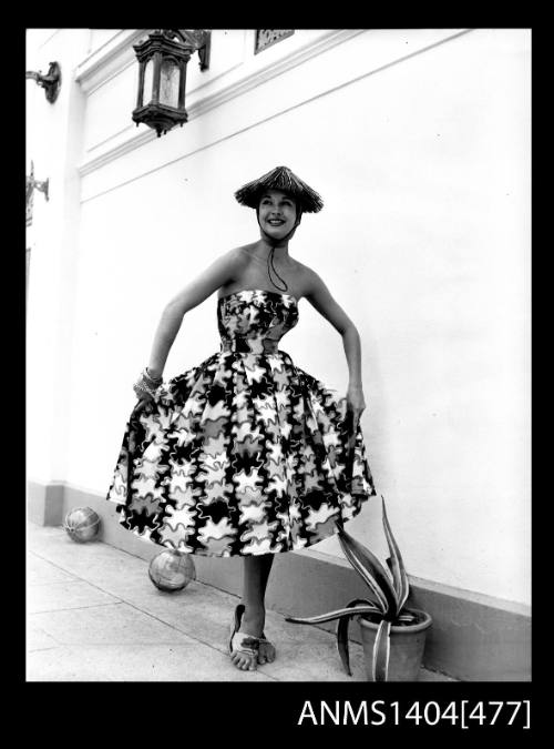 Photographic negative of model in cocktail dress against a white wall