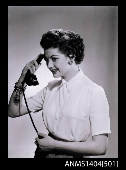 Photographic negative of a model posing with a telehpone