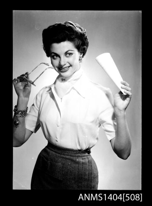 Photographic negative of a model posing with a reading glasses and paper