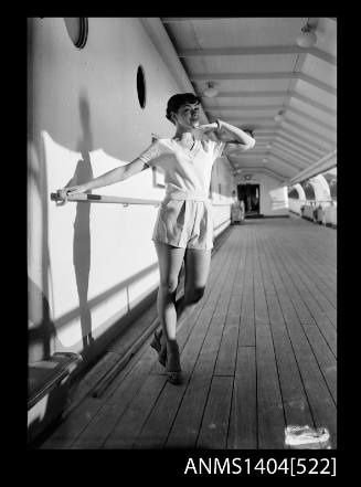 Photographic negative of a model posing in casual wear on a ship