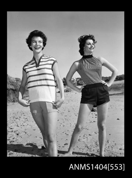 Photographic negative of two models posing in casual clothes on a beach