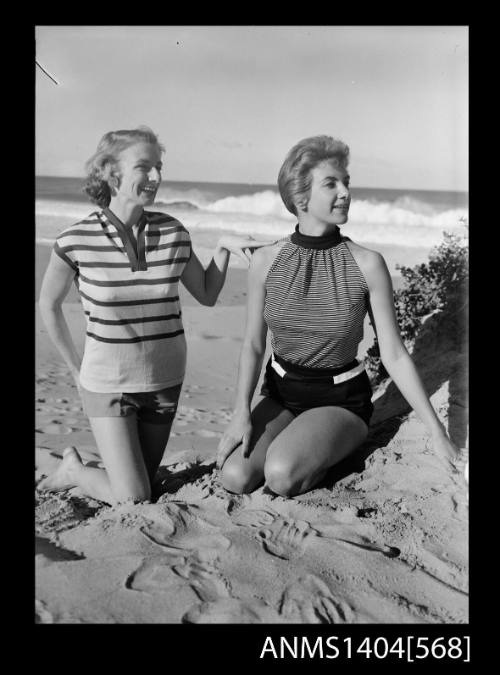 Photographic negative of two models wearing casual wear at the beach