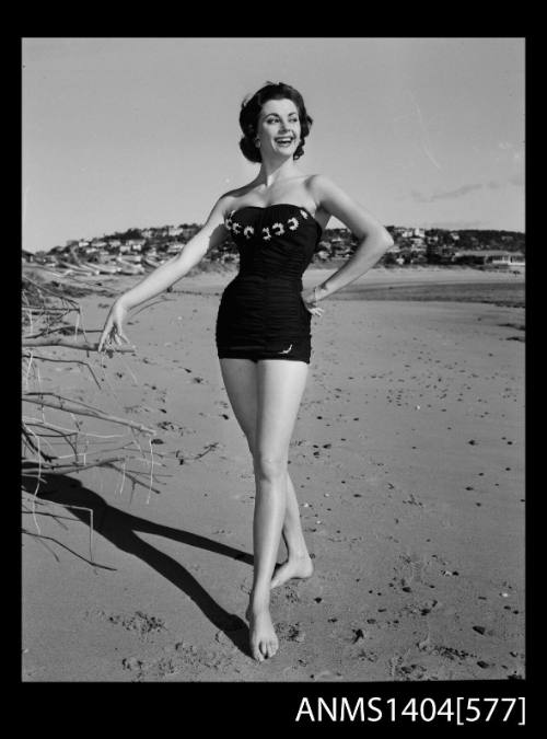 Photographic negative of a swimsuit model posing on a beach