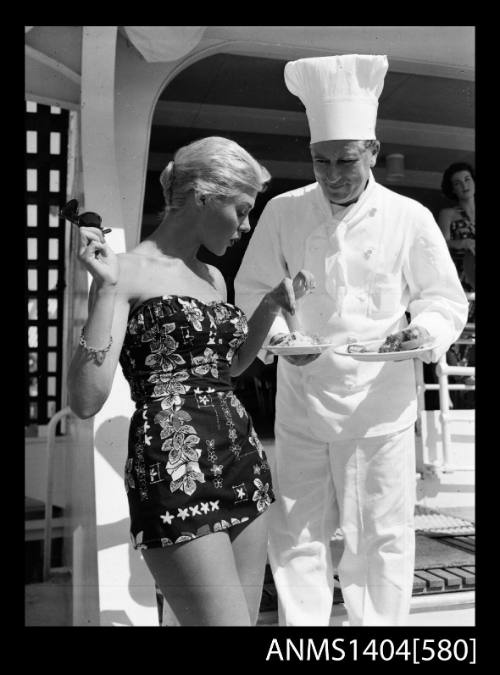 Photographic negative of a swimsuit model posing with a chef