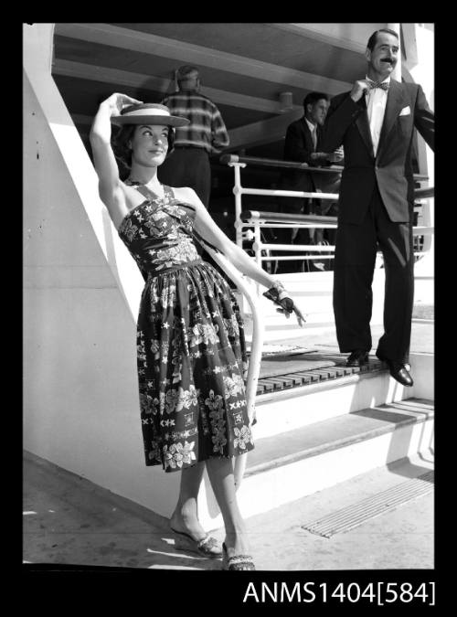 Photographic negative of a model posing in a sundress on a ship