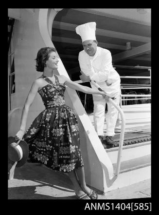 Photographic negative of a model posing with a chef on a ship