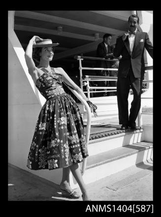 Photographic negative of a model posing in a sundress on a ship