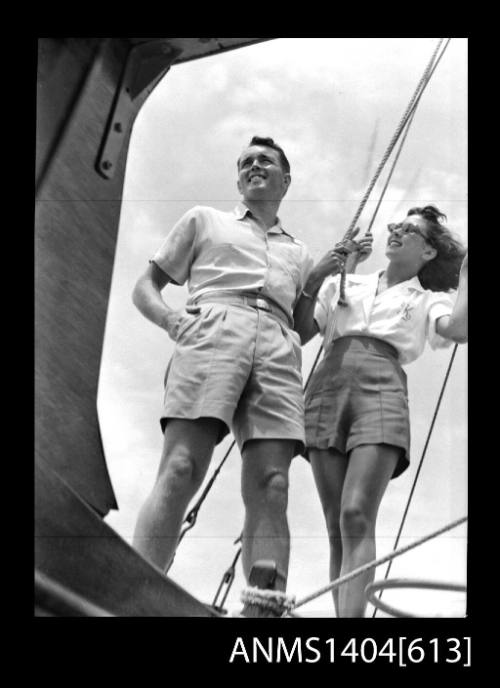 Photographic negative of a man and woman modelling casual wear on a boat