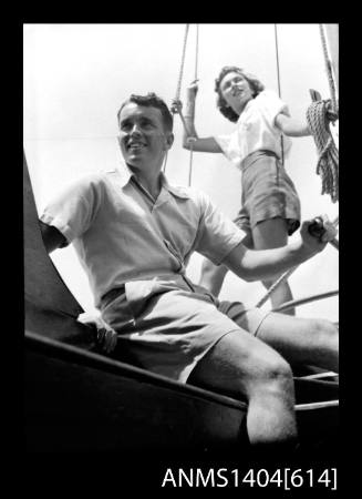 Photographic negative of a man and woman modelling casual wear on a boat