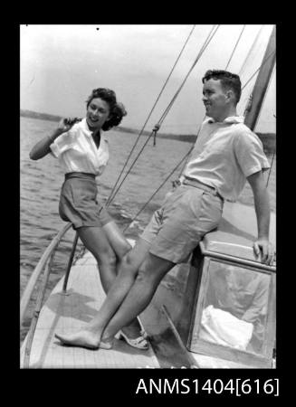 Photographic negative of a man and woman modelling casual wear on a boat