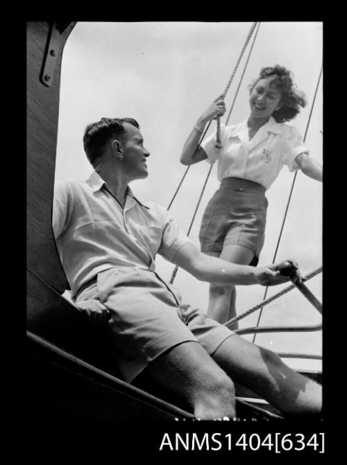 Photographic negative of a man and woman modelling casual wear on a boat