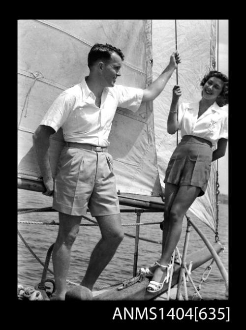 Photographic negative of a man and woman modelling casual wear on a boat