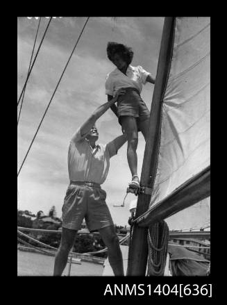 Photographic negative of a man and woman modelling casual wear on a boat