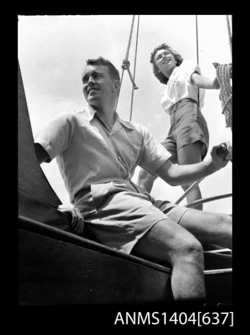 Photographic negative of a man and woman modelling casual wear on a boat