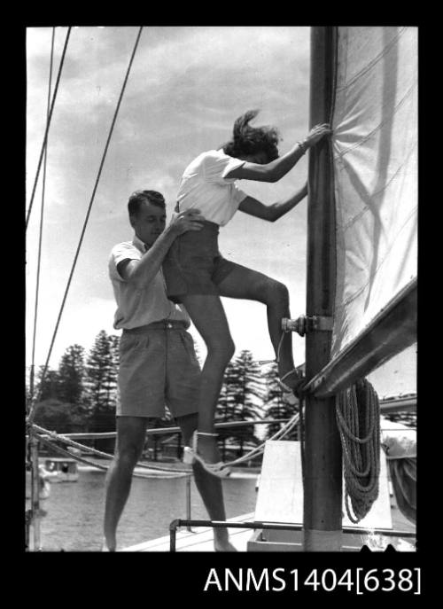 Photographic negative of a man and woman modelling casual wear on a boat