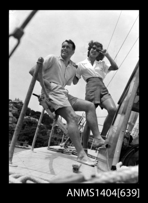 Photographic negative of a man and woman modelling casual wear on a boat