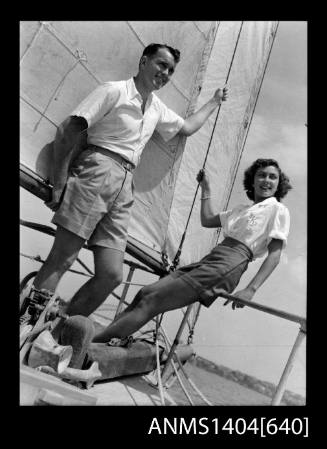 Photographic negative of a man and woman modelling casual wear on a boat