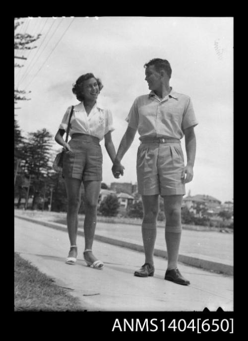 Photographic negative of a man and woman modelling casual wear on a boat