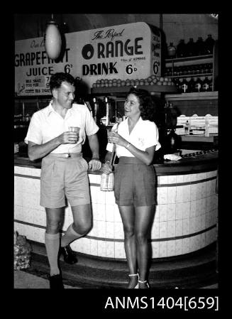 Photographic negative of a man and woman modelling casual wear in a milk bar