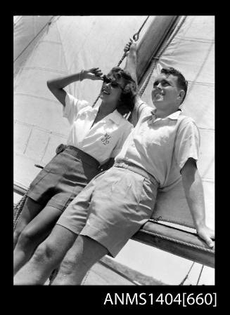 Photographic negative of a man and woman modelling casual wear on a boat