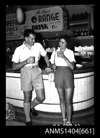 Photographic negative of a man and woman modelling casual wear in a milk bar