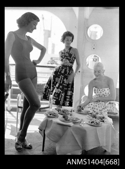 Photographic negative of three models posing on a ship