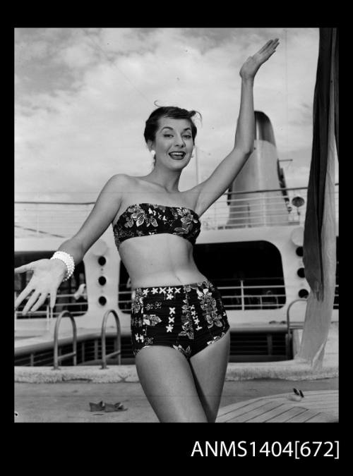 Photographic negative of a swimsuit model posing on a ship