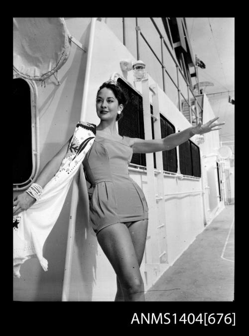 Photographic negative of a swimsuit model posing on a ship