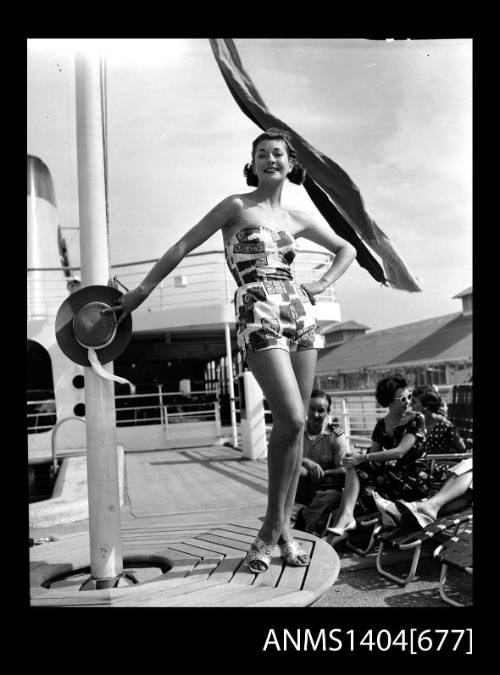 Photographic negative of a swimsuit model posing on a ship