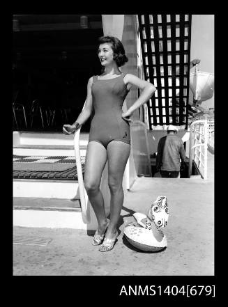 Photographic negative of a swimsuit model posing on a ship