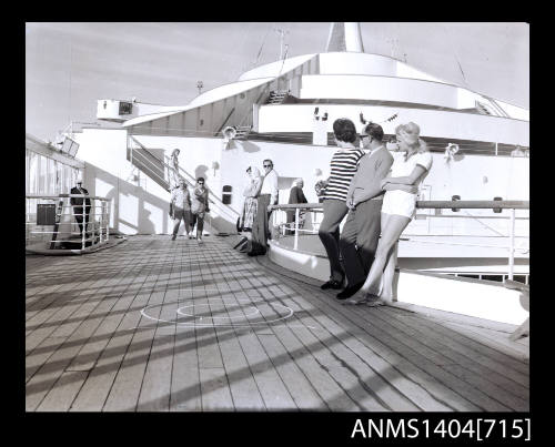 Photographic negative of people playing quoits on a ship