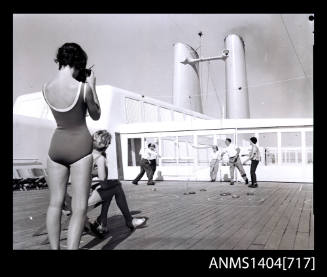 Photographic negative of a game of quoits on a ship
