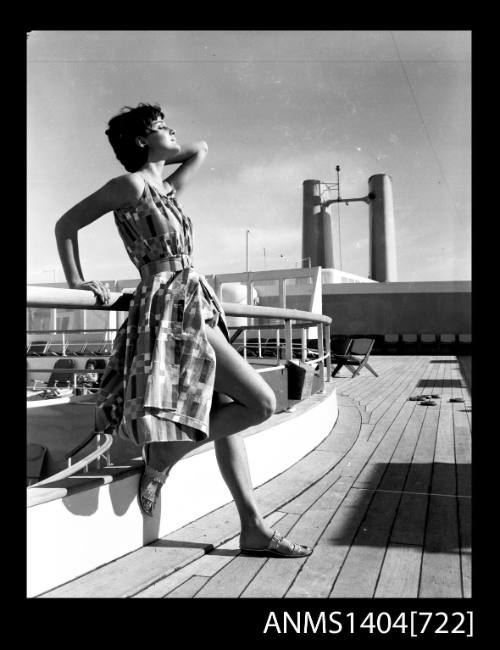 Photographic negative of model posing on a ship