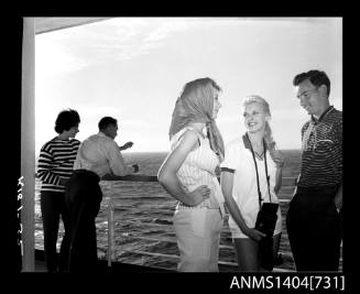 Photographic negative of a several models posing on a ship