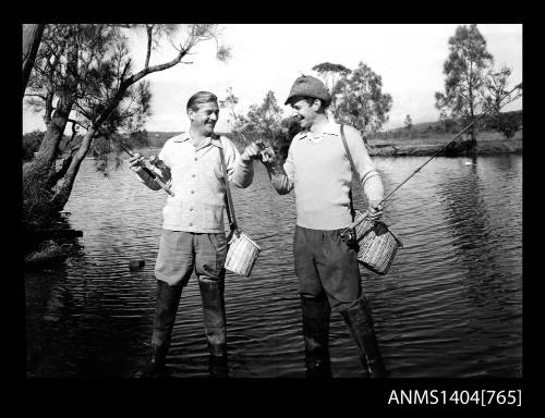 Photographic negative of two men fishing in a river