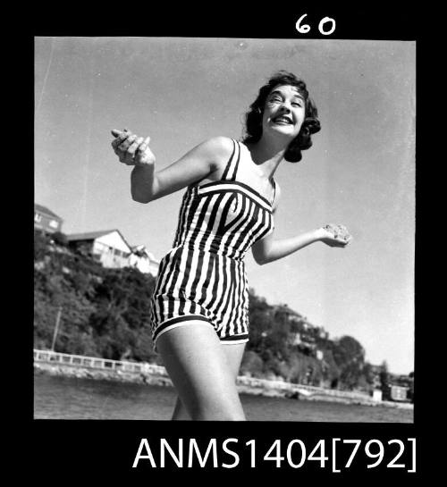 Photographic negative showing a swimsuit model posing on a beach