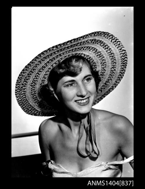 Photographic negative of a model posing with a hat