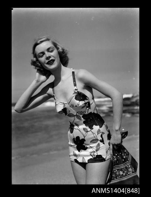 Photographic negative of a swimsuit model posing on a beach