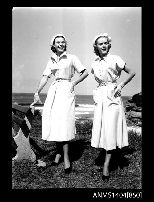 Photographic negative of two models posing near a beach