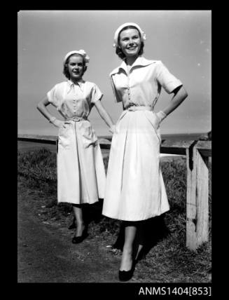 Photographic negative of two models posing near a beach