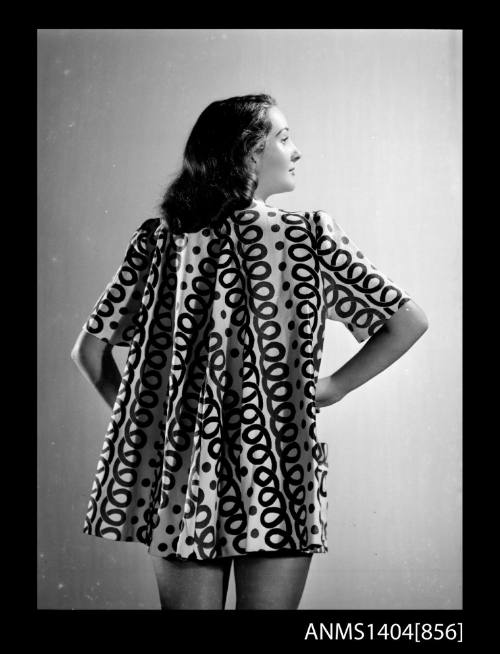 Photographic negative of a model posing in a coat