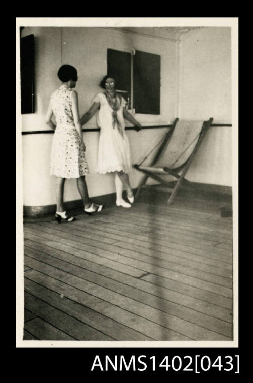 Two female passengers conversing on deck (E & A Line)