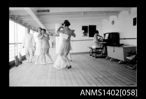 Passengers dancing on deck, woman playing violin seated at piano (E & A Line)  negative of ANMS1402[057]