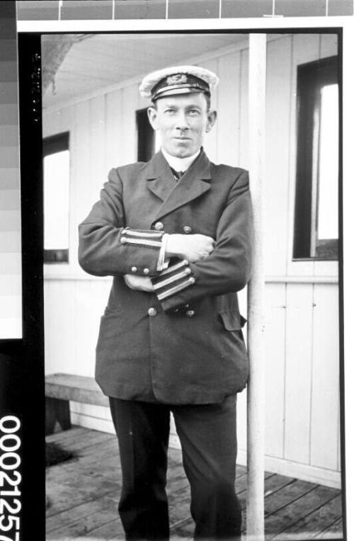 Unidentified merchant mariner standing on a ship's deck