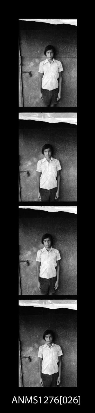 Four black-and-white negatives, joined together, of all the same man, posing for a photograph
