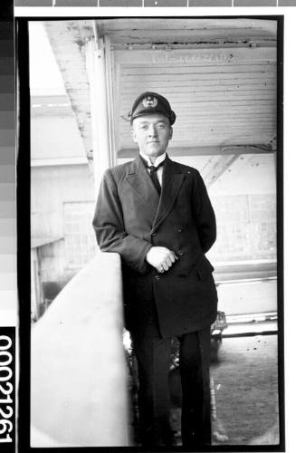 Unidentified merchant mariner with the initials 'H K & Co' on his cap