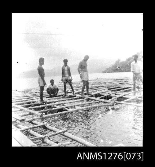 Five people on a pearl production raft on Pearl Island