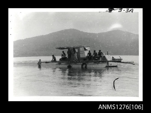 Three Photographs, stapled together, of boats and a wooden raft in Samarai