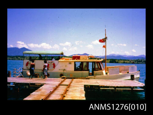 35mm colour transparency of a boat called the BLUE PETER, docked next to a wharf