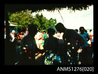 35mm colour transparency of Queen Elizabeth II, Prince Philip and Denis George under a shade cloth during their visit to Papua New Guinea in 1977